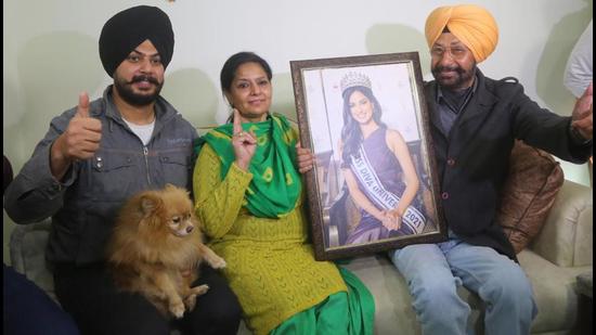 Miss Universe Harnaaz Sandhu’s parents Pritampal Singh Sandhu and Dr Rabinder Kaur Sandhu and brother Harnoor Singh celebrating her winning the title, at their home in Kharar town of Mohali district in Punjab on Monday. (Ravi Kumar/HT)