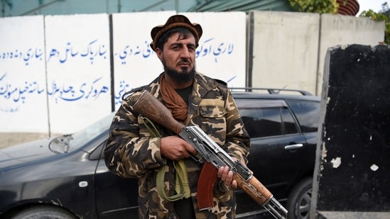 A Taliban fighter stand guards along a roadside in Jalalabad(AFP)