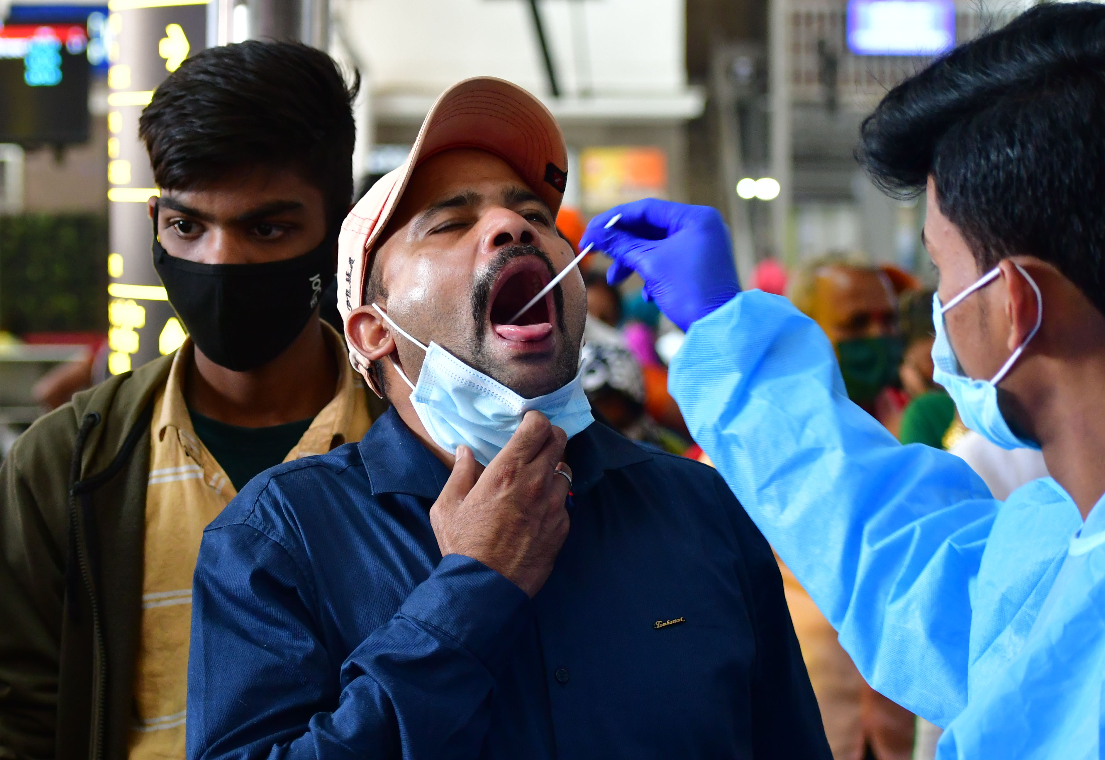 File image of a health worker taking swab sample of a man.&nbsp;