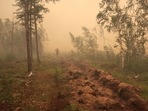 A man digs a control line during the work on extinguishing a forest fire near the village of Magaras in the region of Yakutia, Russia July 17, 2021.&nbsp;(REUTERS)