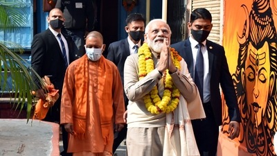 PM Modi with Uttar Pradesh Chief Minister Yogi Adityanath greets the supporters as he arrives at Kaal Bhairav Temple in Varanasi on December 13. (ANI) PM Modi with Uttar Pradesh Chief Minister Yogi Adityanath greets the supporters as he arrives at Kaal Bhairav Temple in Varanasi on December 13. (ANI)