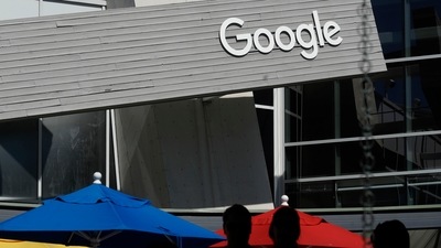 People walk by a Google sign on the company's campus in Mountain View, California (AP) People walk by a Google sign on the company's campus in Mountain View, California (AP)
