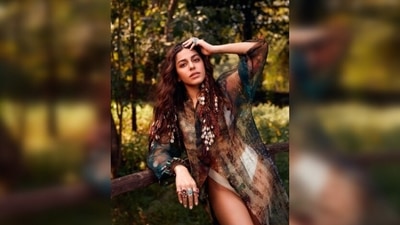 In another still, Alaya F can be seen posing out in the woods in a white bikini and emerald green see-through cape. (Instagram/@elevate_promotions) In another still, Alaya F can be seen posing out in the woods in a white bikini and emerald green see-through cape. (Instagram/@elevate_promotions)