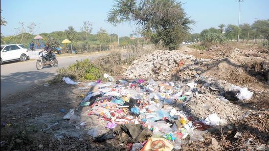 Vacant areas in Sector 48 have been turned into dump yards, leading to insanitation, complain residents. (Ravi Kumar/HT)