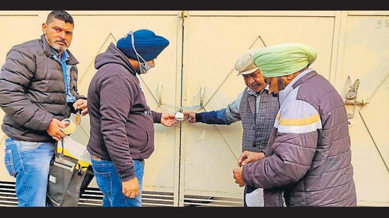 Officials of MC’s building branch sealing an illegal commercial establishment in New BRS Nagar, Ludhiana, on Tuesday. (HT Photo)