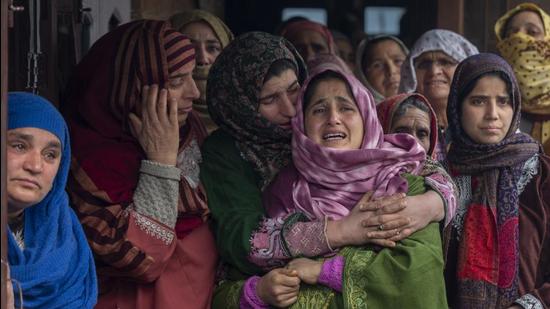Relatives and neighbours at the funeral of Rameez Ahmad, a policeman who was killed in Monday's gun attack, in Yachama, northeast of Srinagar, on Tuesday. (AP) Relatives and neighbours at the funeral of Rameez Ahmad, a policeman who was killed in Monday's gun attack, in Yachama, northeast of Srinagar, on Tuesday. (AP)