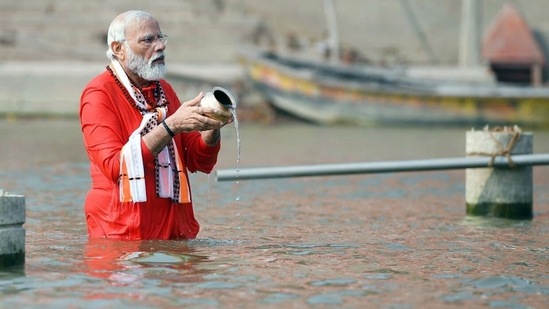 PM Modi takes a dip in the holy river of Ganga and offers prayers before the inauguration of the Kashi Vishwanath Dham Corridor in Varanasi.(ANI )