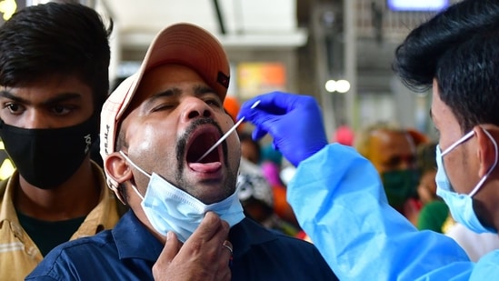 File image of a health worker taking swab sample of a man.&nbsp;