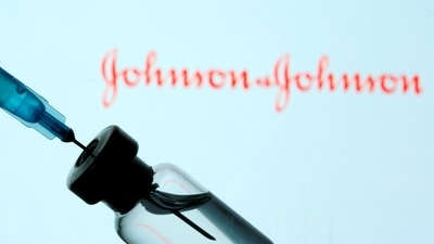 A vial and syringe are seen in front of a displayed Johnson&amp;Johnson logo in this illustration.&nbsp; (REUTERS)