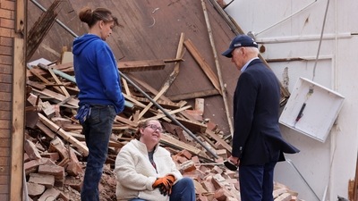 U.S. President Joe Biden speaks with a woman as he tours a neighborhood in Mayfield, Kentucky, US (REUTERS)