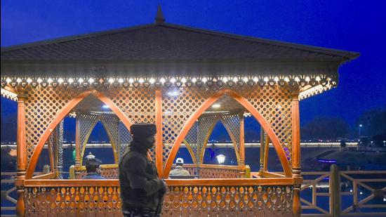 A security officer stands guard during a high alert after a militant attack at Zewan in which three policemen were killed, in Srinagar on Tuesday. (PTI) A security officer stands guard during a high alert after a militant attack at Zewan in which three policemen were killed, in Srinagar on Tuesday. (PTI)