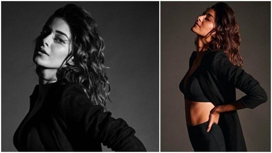 The stunning Ananya Panday ditched fancy designer lehengas and gowns and posed in a black sports bra, high-rise boy shorts and a cape.(Instagram/@ananyapanday)