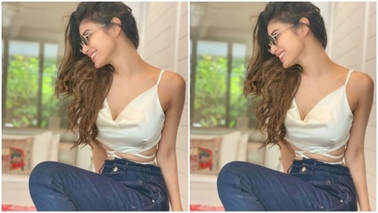 Mouni is setting vacay fashion goals for us. In a slip-in satin white cropped top and a pair of blue denims, Mouni posed for the cameras.(Instagram/@imouniroy)