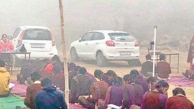 Students braving cold: Students in GHS Sunet were seated in the ground of the school to take their exams. Students were seen discussing and writing their exams while the teachers in-charges were seen seated on the chairs sipping tea in front of the students, Ludhiana on, December 16, 2021. (HT Photo) Students braving cold: Students in GHS Sunet were seated in the ground of the school to take their exams. Students were seen discussing and writing their exams while the teachers in-charges were seen seated on the chairs sipping tea in front of the students, Ludhiana on, December 16, 2021. (HT Photo)