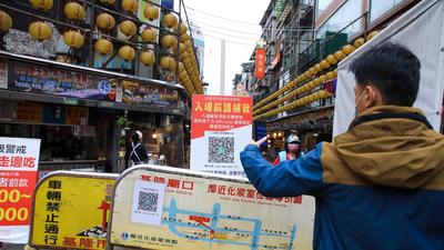 A visitor uses a smartphone to scan a QR code for a real name registration system prior to entering the night market in Keelung, Taiwan. Taiwan, home to several major producers of leading-edge semiconductors, has been among the biggest beneficiaries of a global rebound in trade as the pandemic eases. (Bloomberg) A visitor uses a smartphone to scan a QR code for a real name registration system prior to entering the night market in Keelung, Taiwan. Taiwan, home to several major producers of leading-edge semiconductors, has been among the biggest beneficiaries of a global rebound in trade as the pandemic eases. (Bloomberg)