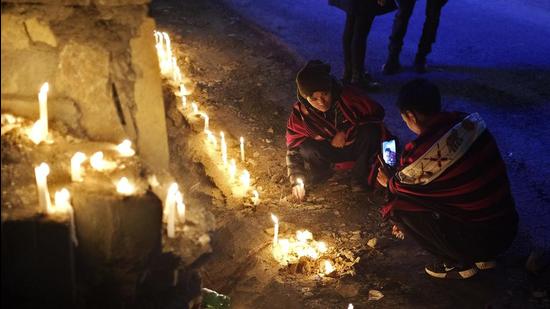 A Naga man takes a photograph of another lighting a candle in memory of fourteen civilians killed by Indian army soldiers earlier this month in Nagaland. The killings prompted calls for the revocation of the Armed Forces Special Powers Act, or AFSPA, that gives security forces sweeping powers to search, seize and even shoot suspects (AP) A Naga man takes a photograph of another lighting a candle in memory of fourteen civilians killed by Indian army soldiers earlier this month in Nagaland. The killings prompted calls for the revocation of the Armed Forces Special Powers Act, or AFSPA, that gives security forces sweeping powers to search, seize and even shoot suspects (AP)