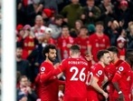 Liverpool's Mohamed Salah celebrates with teammates after scoring his side's second goal during the English Premier League soccer match between Liverpool and Newcastle United at Anfield stadium in Liverpool, England.