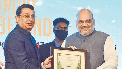 FICCI president Uday Shankar presents 'Green Certificate' to Union minister Amit Shah at the Annual Convention and 94th Annual General Meeting of FICCI, in New Delhi, on Friday. (ANI)