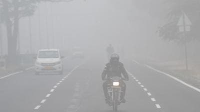 Commuters make way through thick fog on the Sector 42-43 dividing road in Chandigarh on Friday. Similar weather conditions will continue in the coming days. (Keshav Singh/HT) Commuters make way through thick fog on the Sector 42-43 dividing road in Chandigarh on Friday. Similar weather conditions will continue in the coming days. (Keshav Singh/HT)