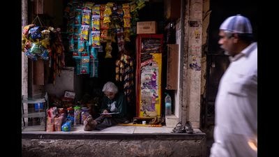 Any place is a great place to read: A woman in her shop in New Delhi. (CHANDAN KHANNA/AFP via Getty Images)