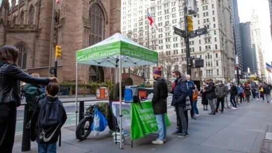 People line up for PCR and Rapid Antigen Covid-19 tests on Wall Street in the Financial District in New York on Thursday.(AP Photo)