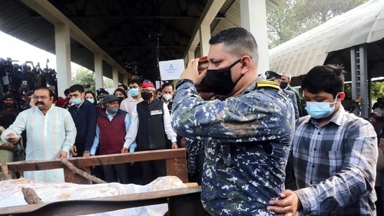 Late Group Captain Varun Singh's brother Navy Lt Commander Tanuj Singh and son Radduman Singh perform the last rites during his cremation, in Bhopal on Friday. (ANI)