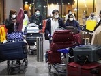 Passengers wearing protective face masks wait to exit upon arrival at Chhatrapati Shivaji Maharaj International Airport in Mumbai.&nbsp;