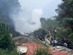 People stand near the debris of the Russian-made Mi-17V5 helicopter in Tamil Nadu.(Reuters)