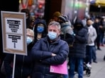 People wait in line at a COVID-19 testing site in Times Square, in New York.