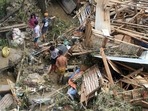 Residents salvage belongings from their destroyed houses at Talisay in Cebu province on December 17, 2021, a day after Super Typhoon Rai hit. &nbsp;