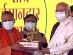 Prime Minister Narendra Modi being felicitated by Uttar Pradesh chief minister Yogi Adityanath at the foundation stone-laying ceremony of Ganga Expressway, in Shahjahanpur on Saturday. (ANI Photo) Prime Minister Narendra Modi being felicitated by Uttar Pradesh chief minister Yogi Adityanath at the foundation stone-laying ceremony of Ganga Expressway, in Shahjahanpur on Saturday. (ANI Photo)