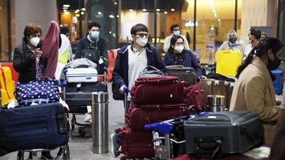 Passengers wearing protective face masks wait to exit upon arrival at Chhatrapati Shivaji Maharaj International Airport in Mumbai.&nbsp; (File Photo / REUTERS)