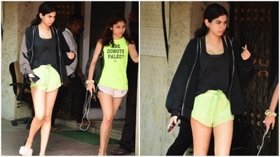 Khushi blended style and comfort for the gym today. She wore a solid black tank top paired with neon green gym shorts, flaunting her long legs and statuesque frame. A black open zipper jacket layered on top of the gym outfit completed Khushi's workout look. (HT Photos/Varinder Chawla)