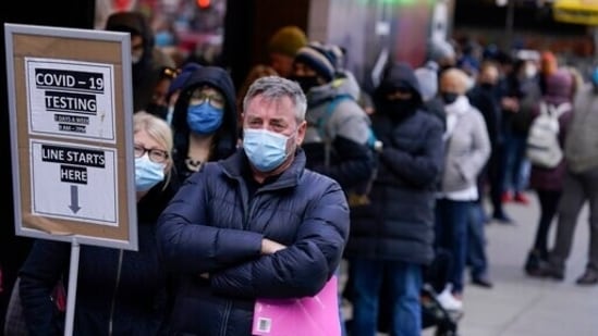 People wait in line at a COVID-19 testing site in Times Square, in New York.(AP File Photo)