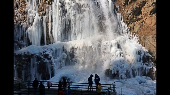 A view of a frozen waterfall in the Drung region of Tangmarg, about 50 km from Srinagar. On Thursday, the higher reaches of Kashmir received light snowfall. In Ladakh, Dras recorded bone-chilling -19.1°C while it was – 17°C in Leh during the night. (Waseem Andrabi/HT)