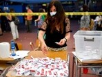 An electoral worker counts ballot papers after polls closed during the presidential run-off election in Santiago, Chile, Sunday, Dec. 19, 2021. (AP)