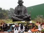 Suspended Rajya Sabha MPs from opposition parties protest near Mahatma Gandhi statue at Parliament House. (HT File Photo) Suspended Rajya Sabha MPs from opposition parties protest near Mahatma Gandhi statue at Parliament House. (HT File Photo)