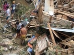 Residents salvage belongings from their destroyed houses at Talisay in Cebu province.(AFP) Residents salvage belongings from their destroyed houses at Talisay in Cebu province.(AFP)