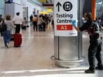 A worker sanitises a sign at the International arrivals area of Terminal 5 in London's Heathrow Airport, Britain.(Reuters / File)