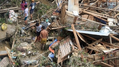 Residents salvage belongings from their destroyed houses at Talisay in Cebu province. (AFP) Residents salvage belongings from their destroyed houses at Talisay in Cebu province. (AFP)