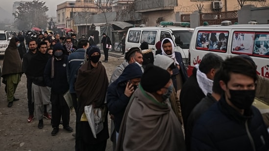 People queue to enter the passport office at a checkpoint in Kabul on December 19, 2021, after Afghanistan's Taliban authorities said they will resume issuing passports.&nbsp;(AFP)