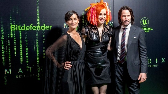 The Matrix Resurrections actor Carrie-Anne Moss, director Lana Wachowski and actor Keanu Reeves at the film's premiere. Carrie plays Trinity while Keanu plays Neo in the film. (AP/PTI)(AP)