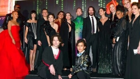 The cast of The Matrix Resurrections pose with director Lana Wachowski, fourth from right, at the premiere of the film at the Castro Theatre in San Francisco. The film will release on December 22. (Jose Carlos Fajardo/Bay Area News Group via AP)(AP)