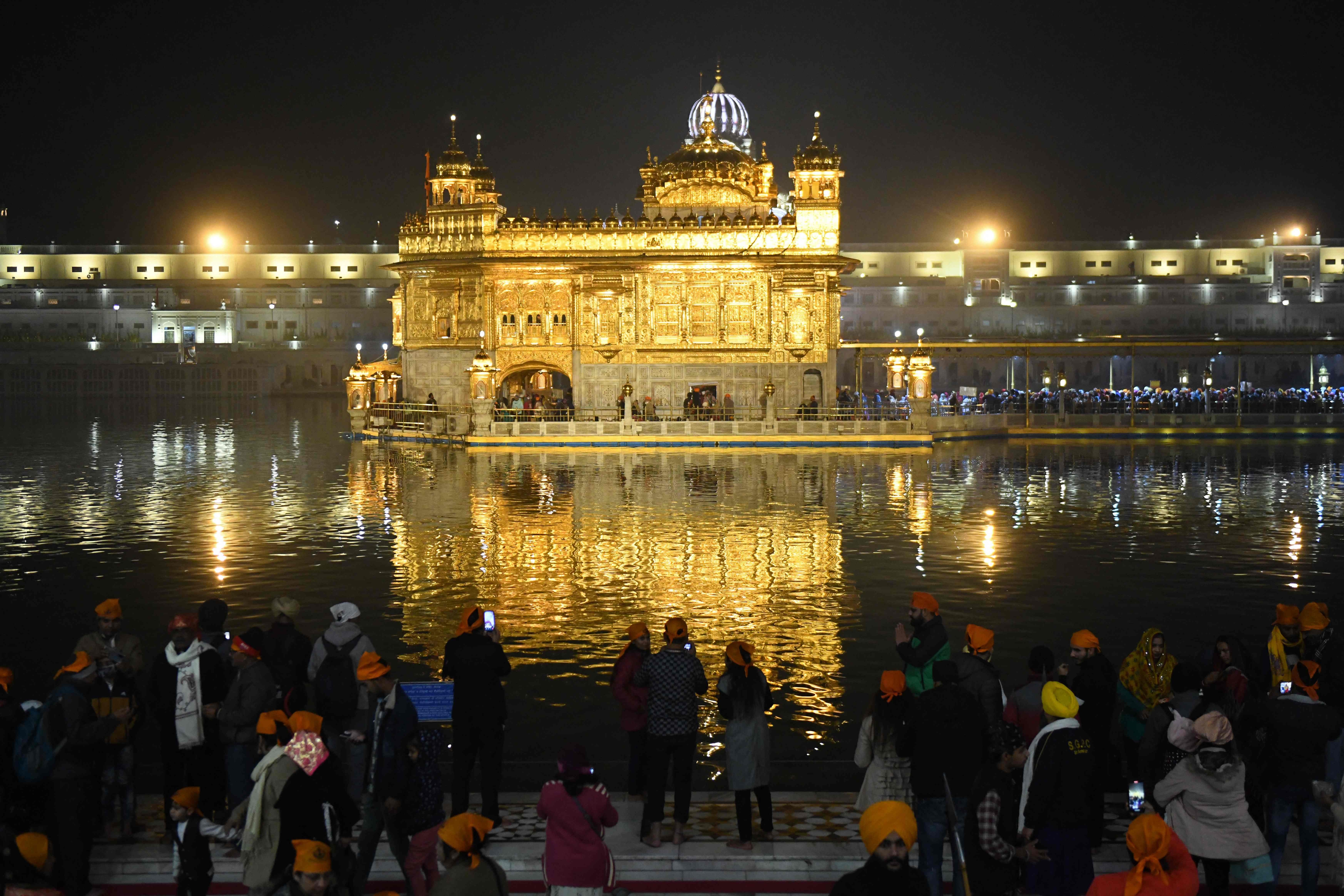 Sikh devotees pay respect at the Golden Temple in Amritsar on December 18, 2021. (AFP) Sikh devotees pay respect at the Golden Temple in Amritsar on December 18, 2021. (AFP)