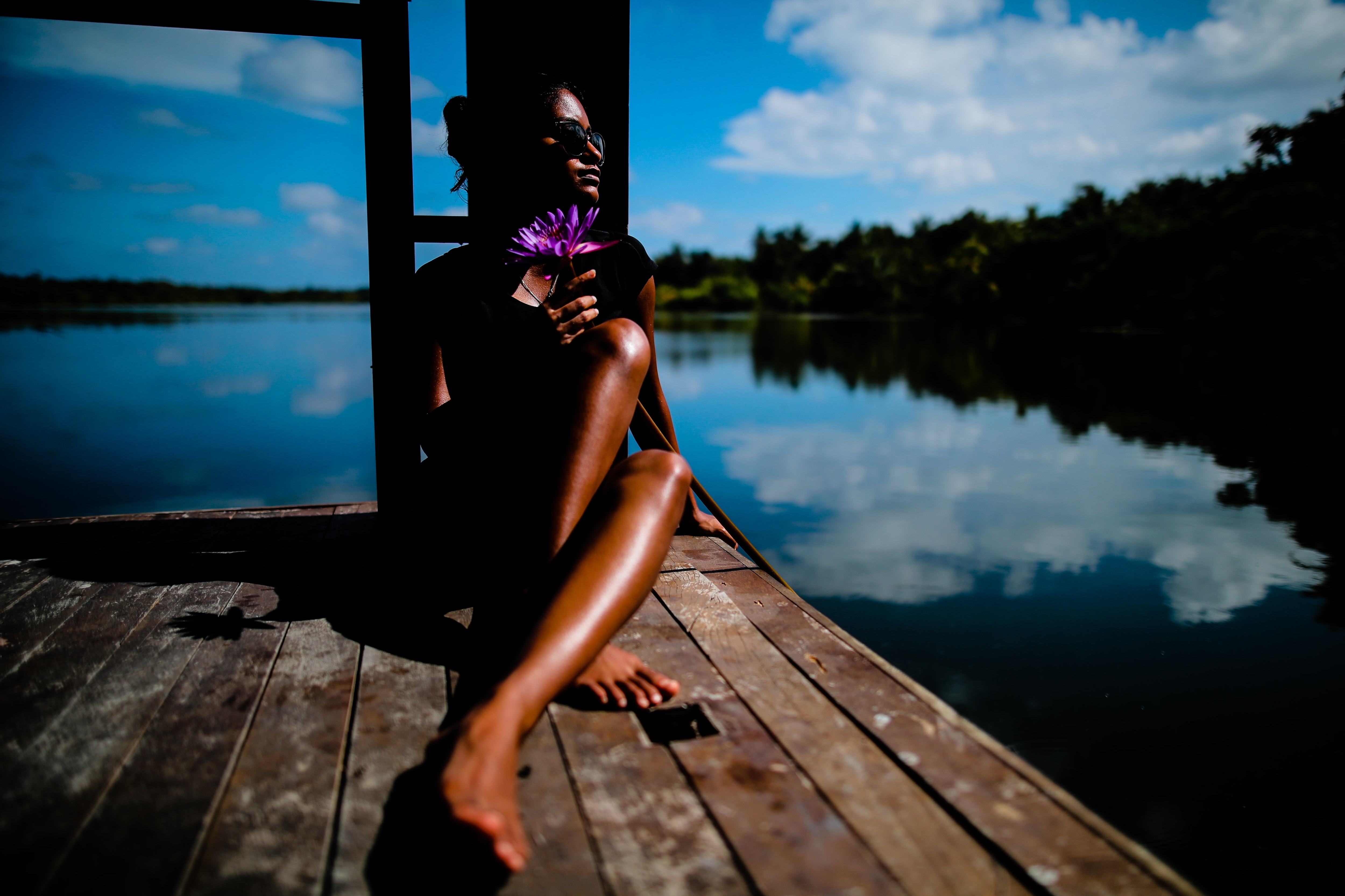 A woman is sitting in the sun.  (Unsplash (for display))