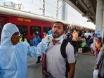 A healthcare worker of BrihanMumbai Municipal Corporation collects swab samples of an outstation passenger for Covid-19 test, at Dadar railway station in Mumbai, on Sunday.(PTI Photo) A healthcare worker of BrihanMumbai Municipal Corporation collects swab samples of an outstation passenger for Covid-19 test, at Dadar railway station in Mumbai, on Sunday.(PTI Photo)