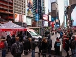 People stand in a queue for Covid-19 test in Times Square, New York City, on December 19.