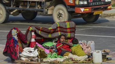 A homeless family braces the cold wave in New Delhi during the weekend. (PTI/File)