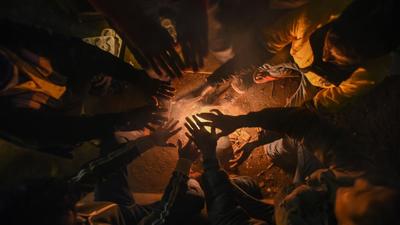 People sit around a bonfire in Delhi on Monday when the city experienced the coldest morning of the season so far. At the Jafarpur station, the minimum temperature was recorded at 2.9 degrees Celsius. (Amal KS/HT Photo)
