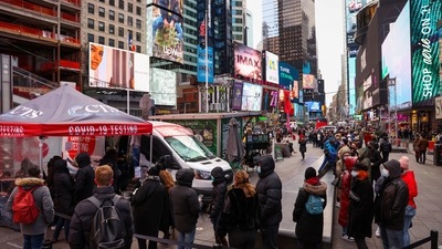 People stand in a queue for Covid-19 test in Times Square, New York City, on December 19. (Reuters Photo)